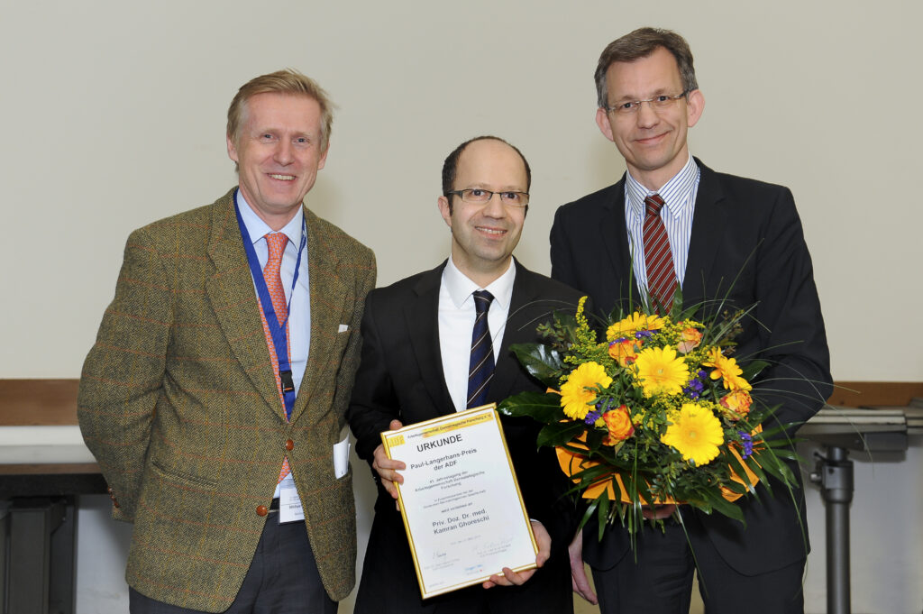 Kamran Ghoreschi (center) — 2014 Paul Langerhans Award winner — with M. Hertl (left) and K. Schäkel (right)